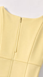 Close-up of yellow dress back zipper and panel seaming details