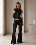 Full front view of the black two-piece set with flared pants and side fringe trim