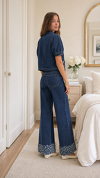 Back view of dark wash blue denim wide leg pants set with floral trim hems