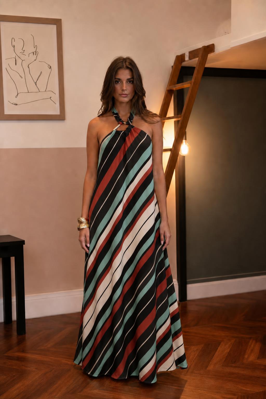 Woman wearing dark teal striped halter maxi dress