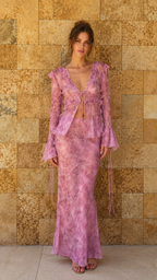 Model wearing lilac sheer lace tie-front top and skirt set