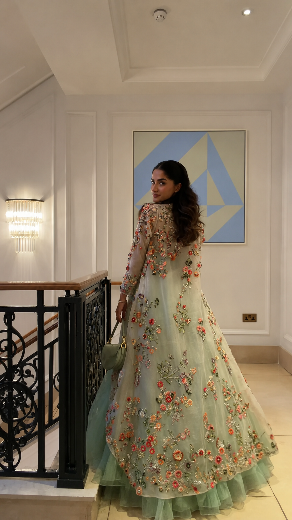 Back view of the mint green gown and sheer floral embroidered cape