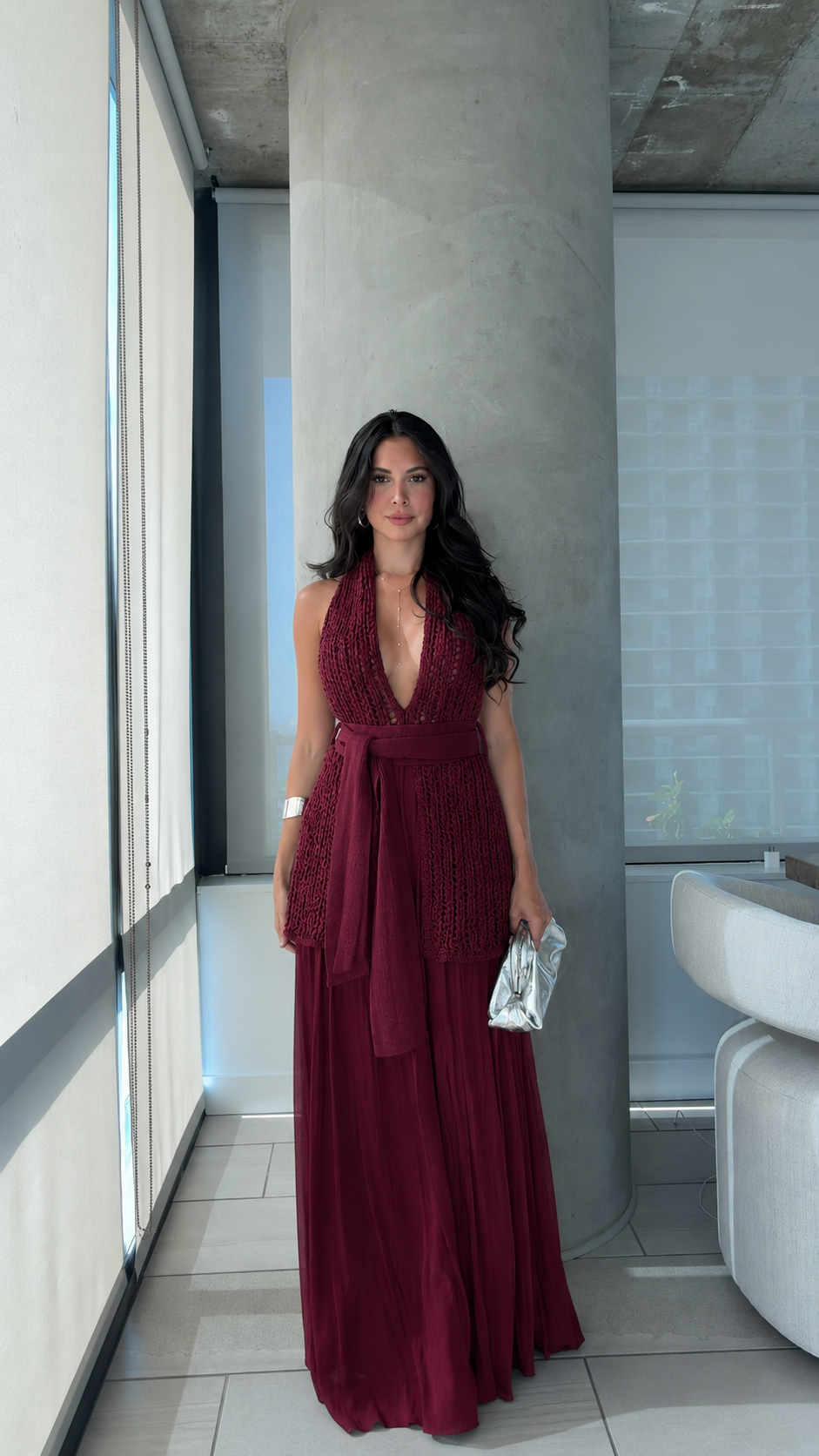 Front view of burgundy halter maxi dress with deep neckline and textured bodice