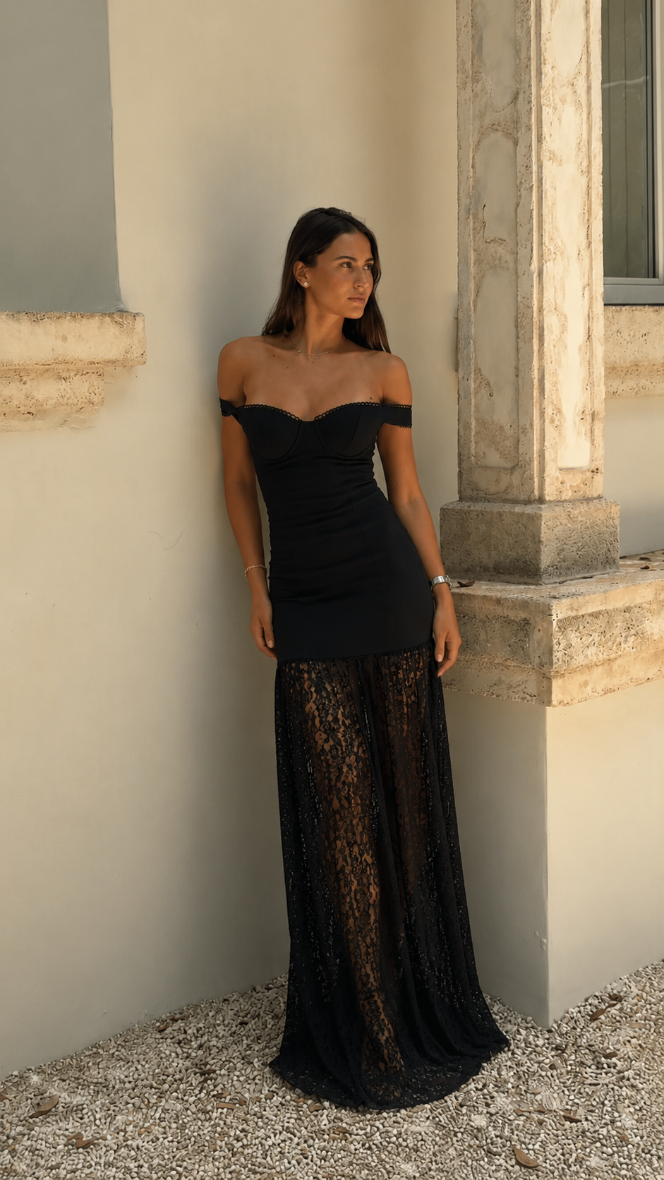 Front view of black off-shoulder ruched maxi dress with sheer lace-look floor-length skirt
