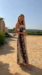 Side view of chocolate and cream floral halter maxi dress
