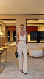 Full front view of ivory elegant jumpsuit with smooth sheen and defined waist