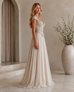 Side view of ivory shimmering cap sleeve sweetheart formal gown