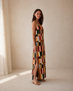 Side view of multicolor patchwork-style maxi dress showing side slit