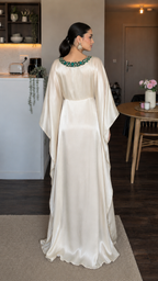 Back view of champagne satin-look maxi dress showing fluid drape and full-length hem