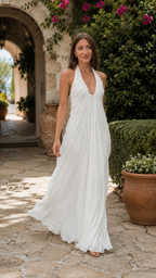 White pleated halter maxi dress shown walking with flowing hem