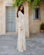 Side view of ivory sheer sleeve lace trim floor-length dress
