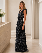 Side view of black polka dot ruffle tiered maxi dress