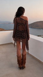 Woman wearing brown boho fringe open-knit tunic, back view