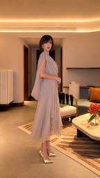Side view of taupe midi dress showing soft drape and asymmetric layered skirt