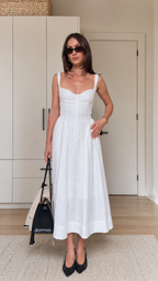 Front view of a white sleeveless sweetheart neck midi dress with a fitted bodice and full midi skirt