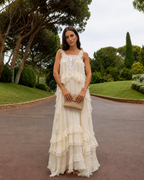 Front view of cream romantic maxi dress with square neckline and tiered finish