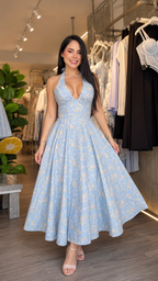 Woman wearing light blue floral halter midi dress